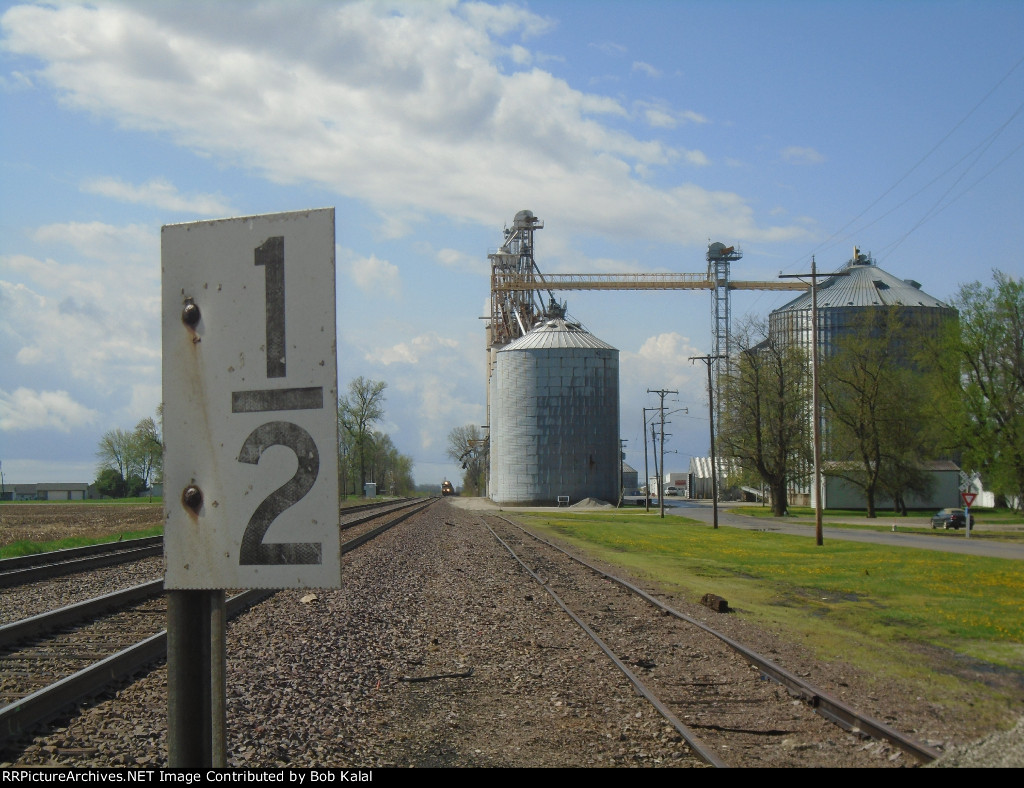 Looking South at NS 8911 & NS 7144 waiting for the go ahead & Grain Elevator & Milepost