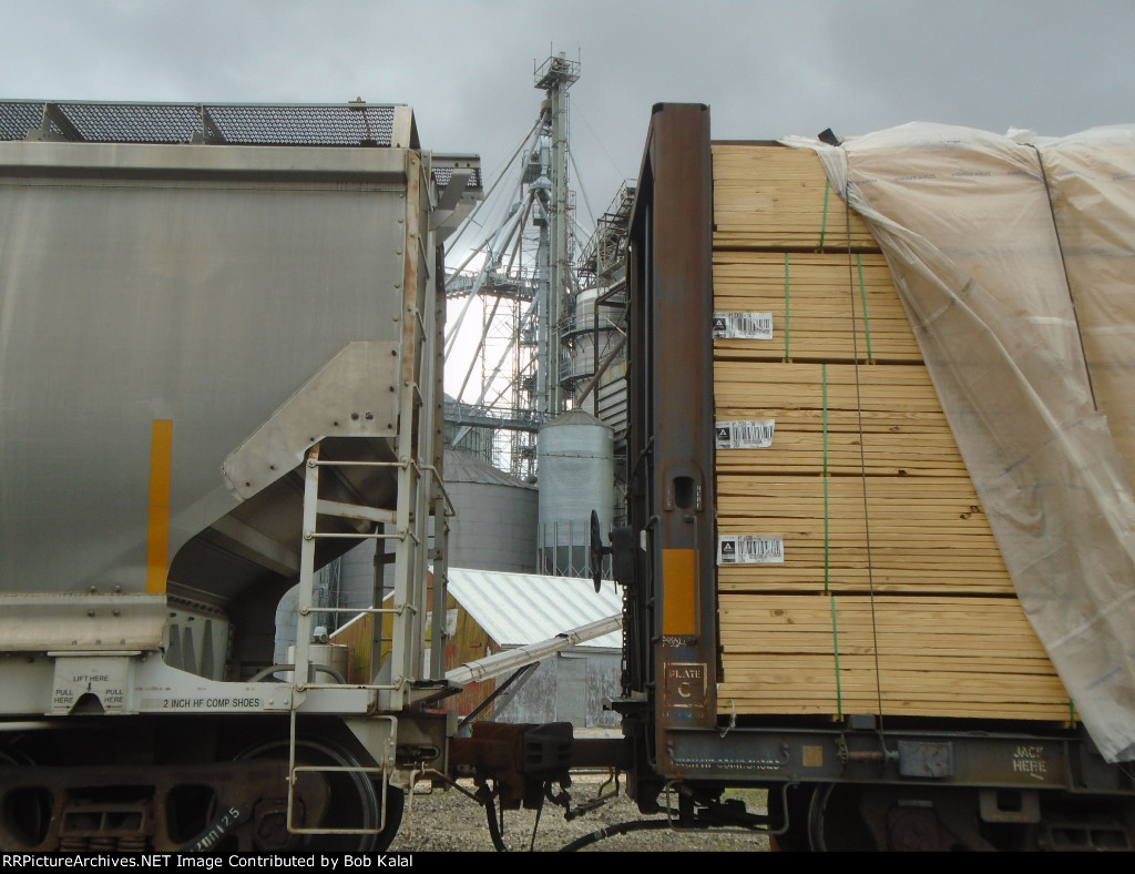 UP heads South comes to a stop with Grain Elevator between cars