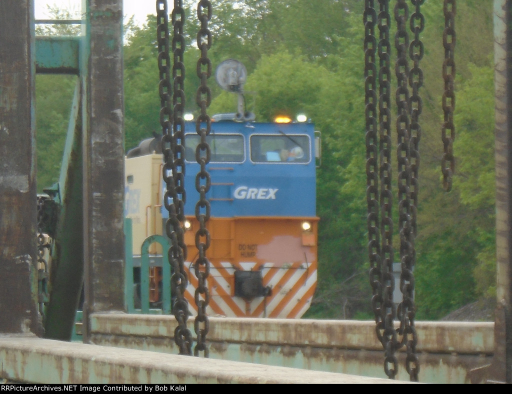 looking thru welded rail cars at the track crew unloading old concrete ties