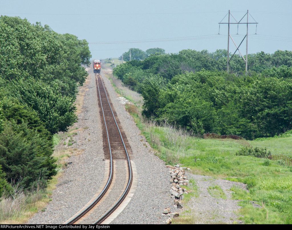 In the distance, a westbound autorack approaches 