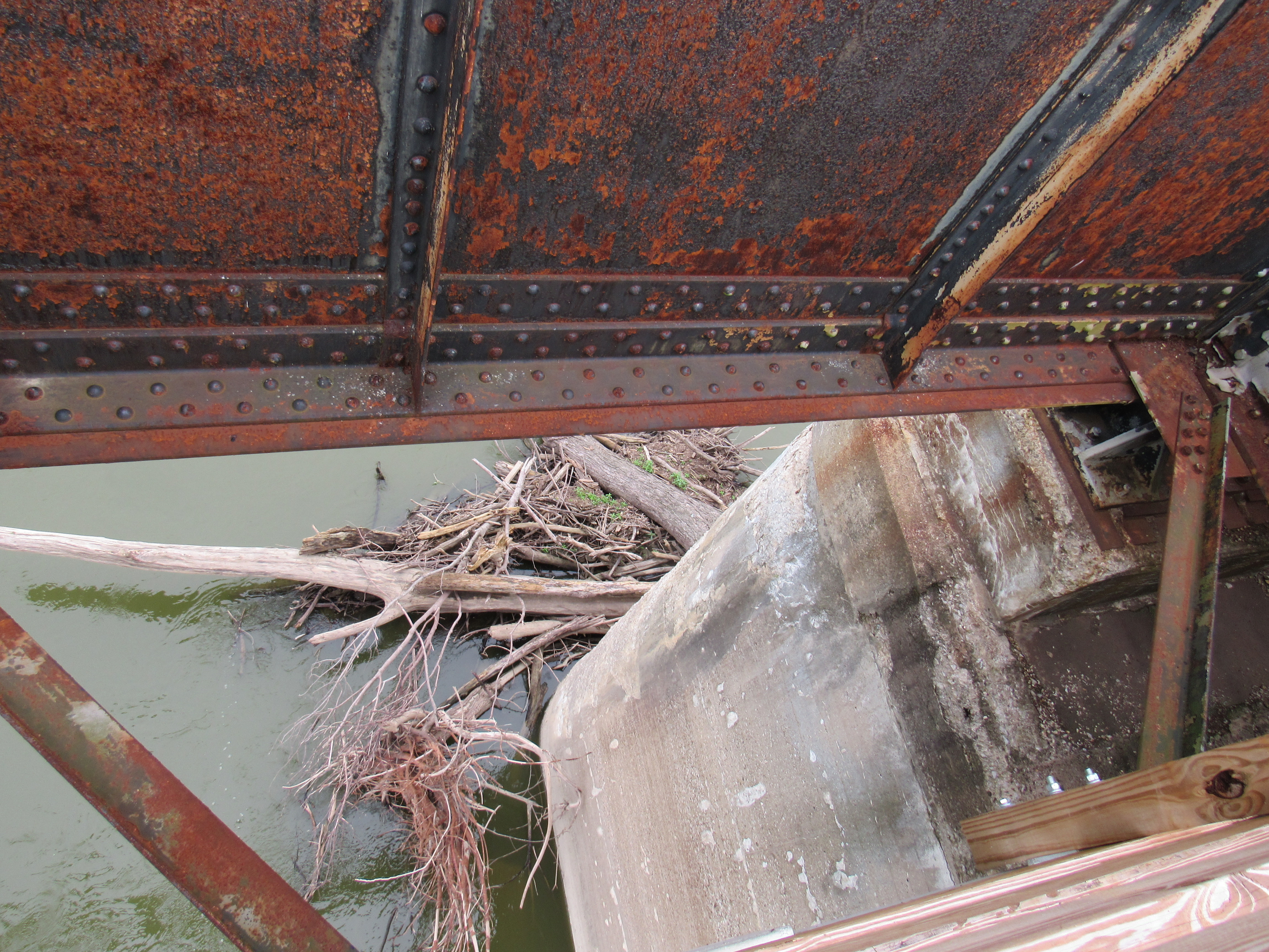 looking down between supports at the lumber built up around abutments