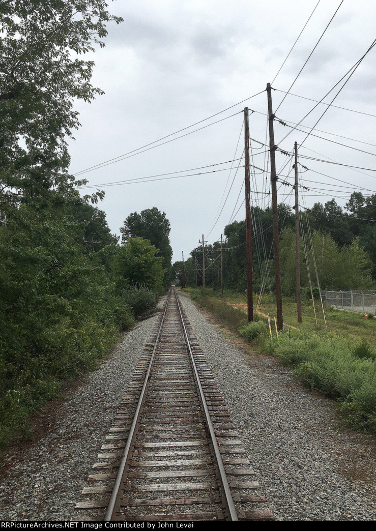 The Tri States Caboose Hop backs north along the Chester Branch past a quarry
