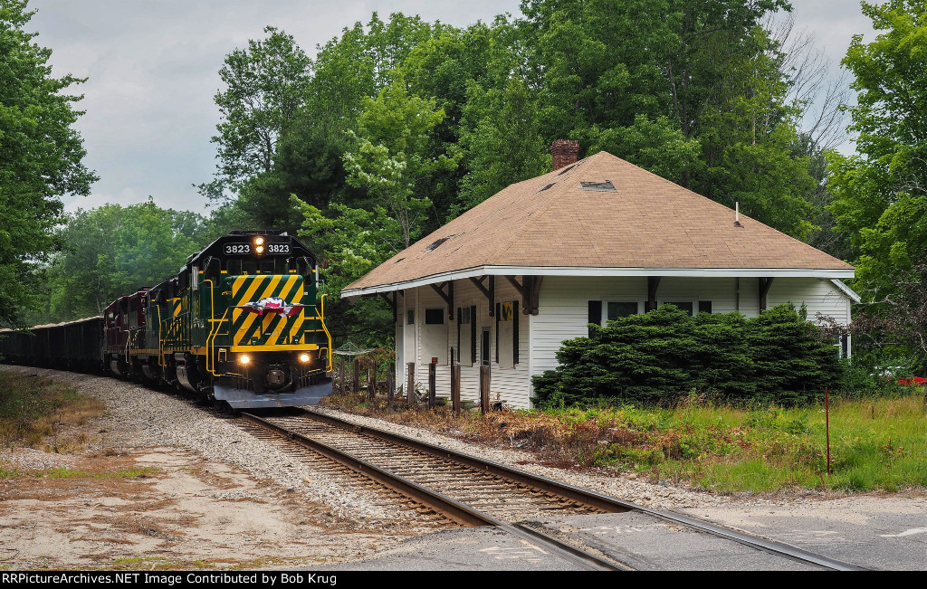Loaded Ossipee Aggregates sand train southbound past the ex-B&M Burleyville depot