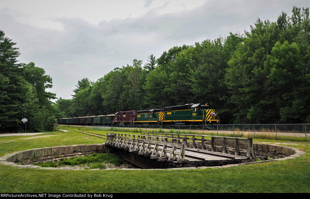 The southbound quarry train rolls past the ex-B&M turntable in Sanbornville, NH