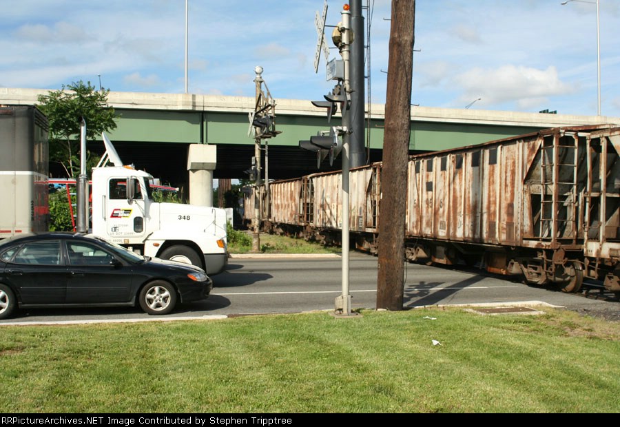 Now crossing the whole highway with ballast cars.