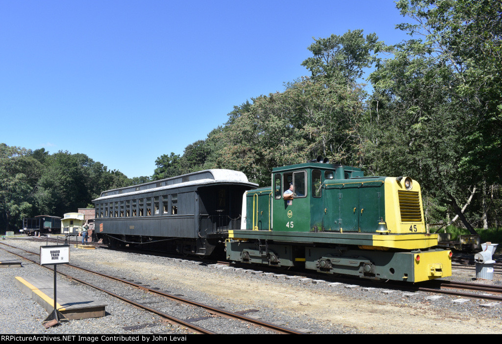 USS Tonner # 45 and the enclosed restored CN Central coach sit in a consist. 