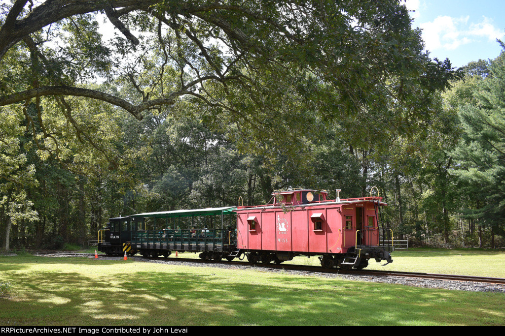 Pine Creek Railroad about to enter the woods from the fields