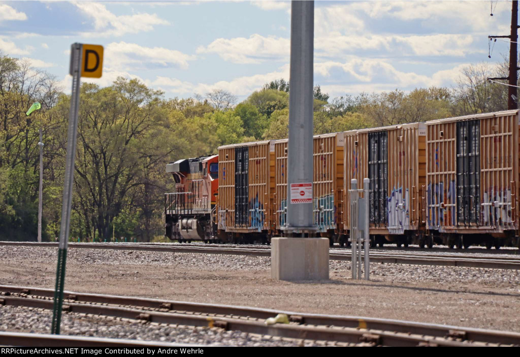 BNSF GEVO coupled nose-in to a string of TTX boxcars in the yard