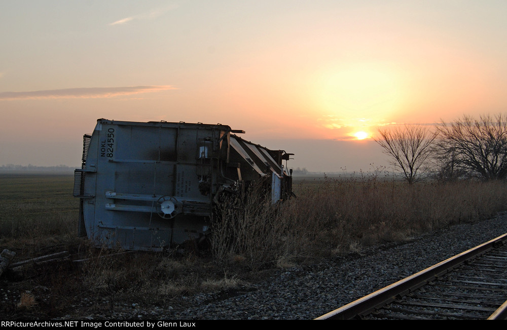 The sunrise reveals the remains of a derailment next to US-81 overpass