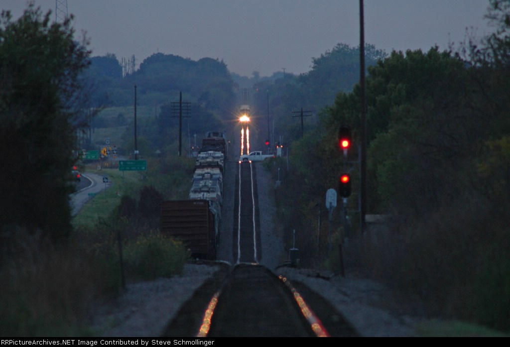 Eastbound Amtrak Texas Eagle meets UP manifest at dusk