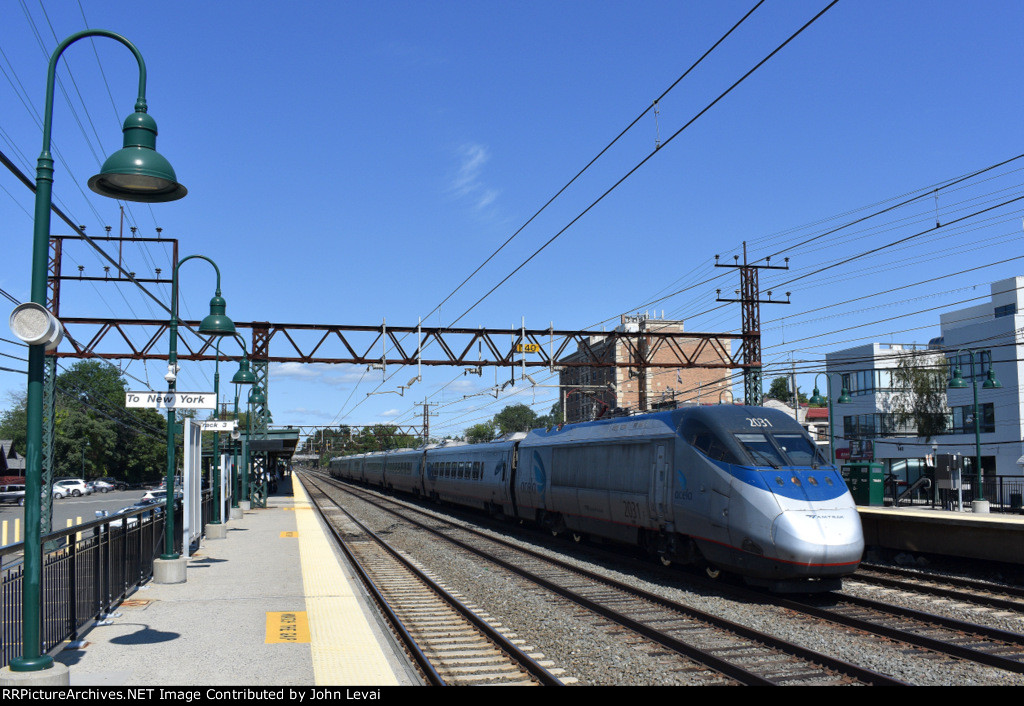 Northbound Mid Afternoon Acela heading away from me passing the Mamaroneck MNR Station