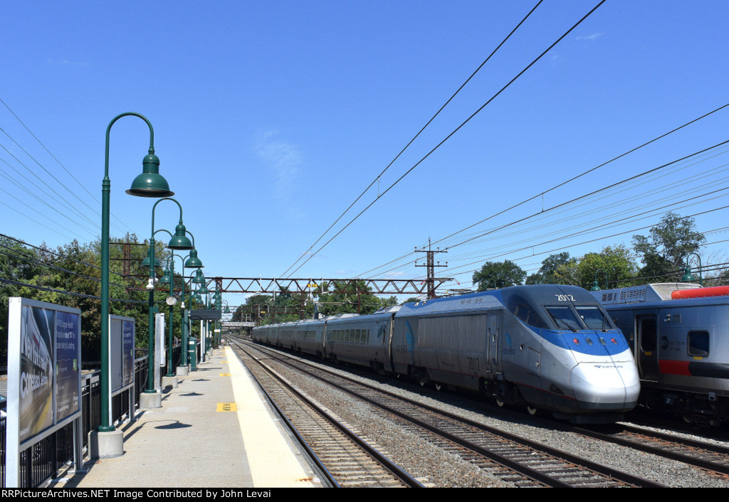 An eastbound Acela overtakes a MNR M8 Set as they both head away from me at Mamaroneck Station