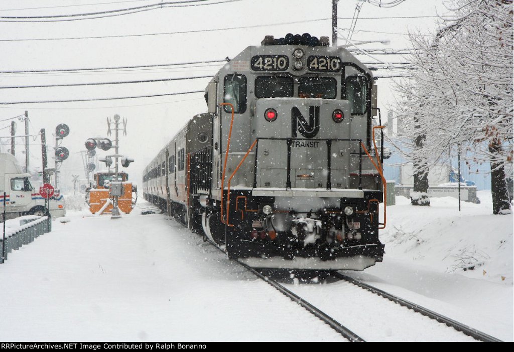 As train # 1622 departs eastward,   GP40PH-2B # 4210 shoves on the rear