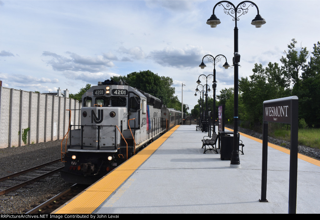 NJT Port Jervis bound train with a NJT Geep passing Wesmont station