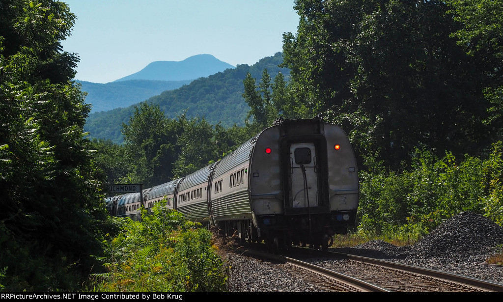 The distinctive profile of the Camels Hump - Vermont's third highest mountain summit is seen rising behind the Vermonter in this going-away shot.