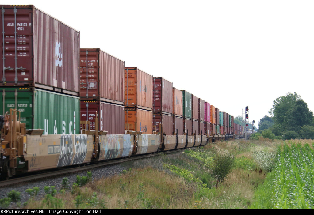 Stacks stretch in the distance as Q123 rolls on to the single track at Wanstead