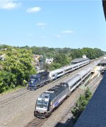 An eastbound deadhead with a Comet Set being pushed by a dual mode is about to pass Cranford Station just as Train # 5525 is departing
