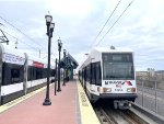 Two HBLRT Trains rest at the 8th St Station platform