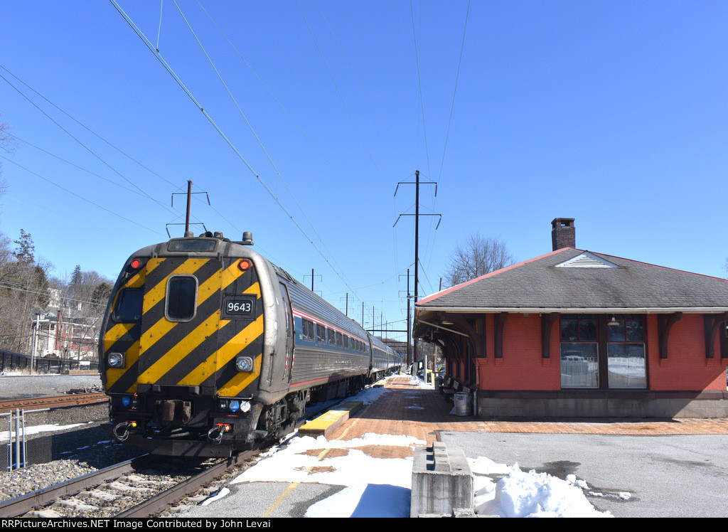 Ex-Metroliner Cab Car # 9643 brings up the rear of Amtrak Train # 666 as it heads toward its next stop of Coatesville Station. The building on the right is the original Parkesburg Station, erected in 1905. Parkesburg is one of the few Amtrak stations with