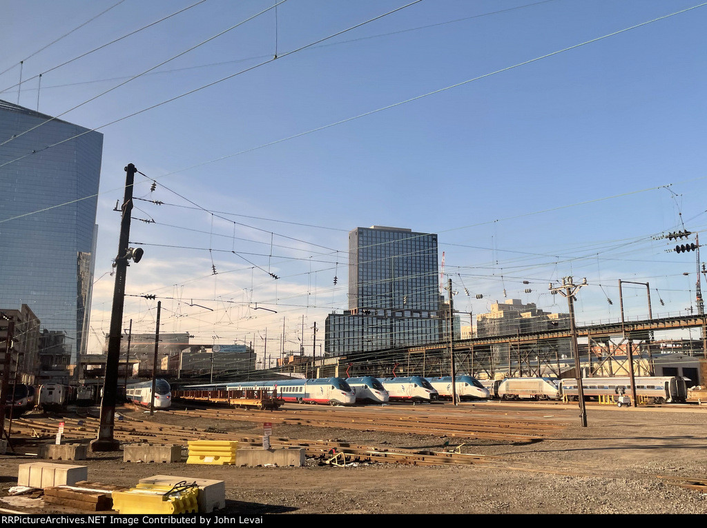 View from Amtrak Train # 661 as we depart 30th Street Station and pass a diversity of rolling stock sitting in Race Street and Penn Coach Yard. There are multiple brand new Avelia Liberty Acela Trainsets in view.