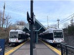 Two NJT HBLRT trains at Tonnelle Avenue Station. The one on the right will be heading to Hoboken Terminal and the one on the left will be heading to West Side Avenue Station 