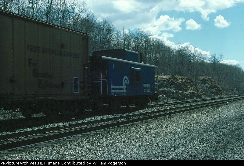 Conrail Caboose No. 23560 brings up the rear of a mixed freight train 