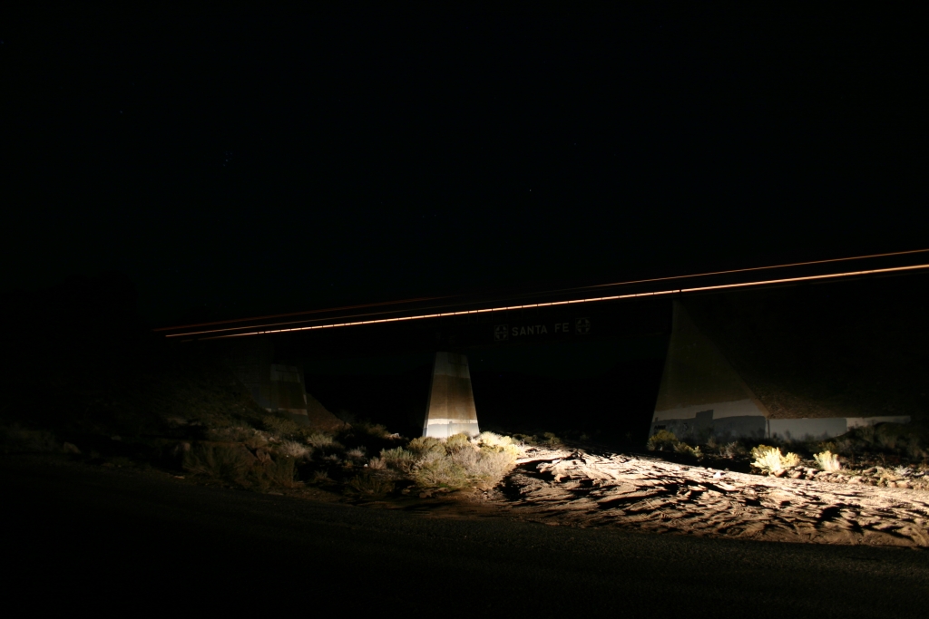 A piece of history shows as the DPU of a grain train cross an old Santa Fe Bridge