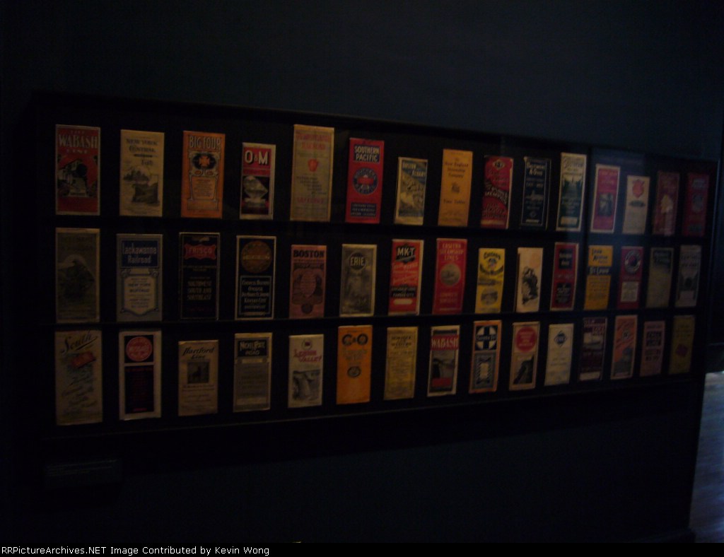 Vintage railroad timetables from the 1890s to the 1920s displayed in Ellis Island