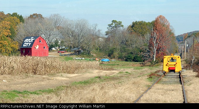 Yellow cars, red barn.