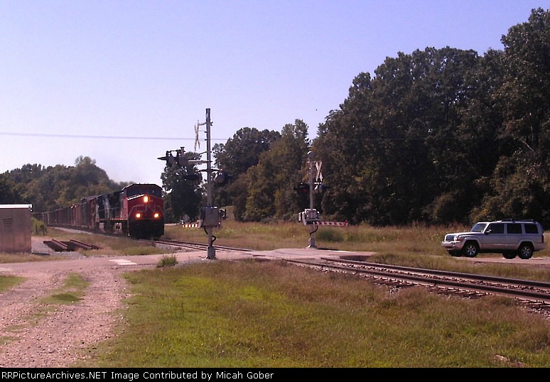 A Jeep SUV waits as a north bound CN Train passes