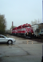 WSOR 4011 leads 4010 and 5 cars to Janesville on a rainy Saturday