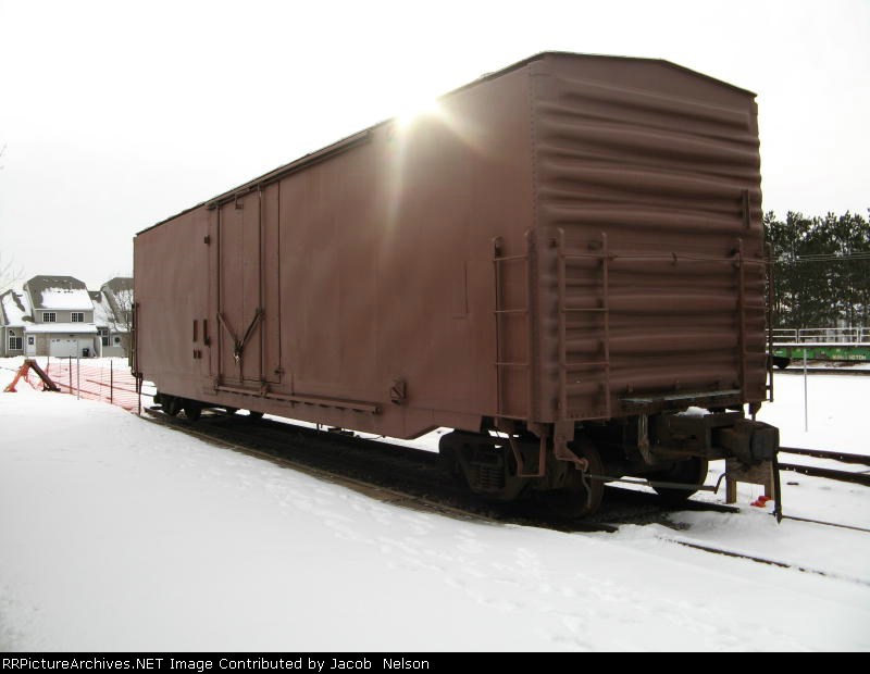 A white box car painted brown
