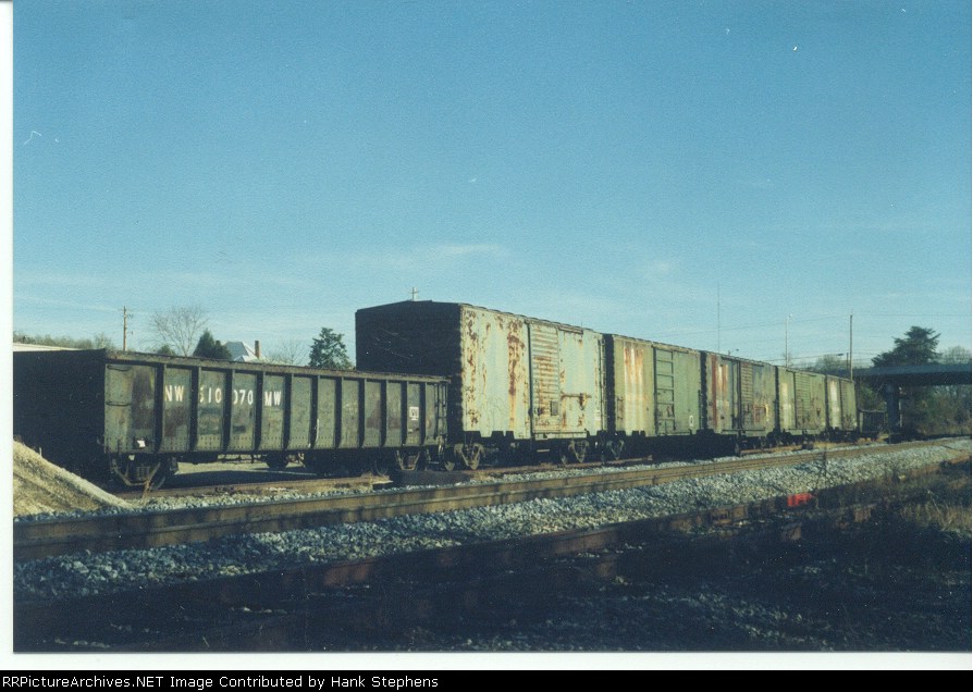 NW 510070MW and a string of company service boxcars turned tool cars for a tie and surface gang working near Opelika in the early 1990s
