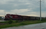 CP 8795 leads a detoured unit grain train across Highway 51 on the Madison branch