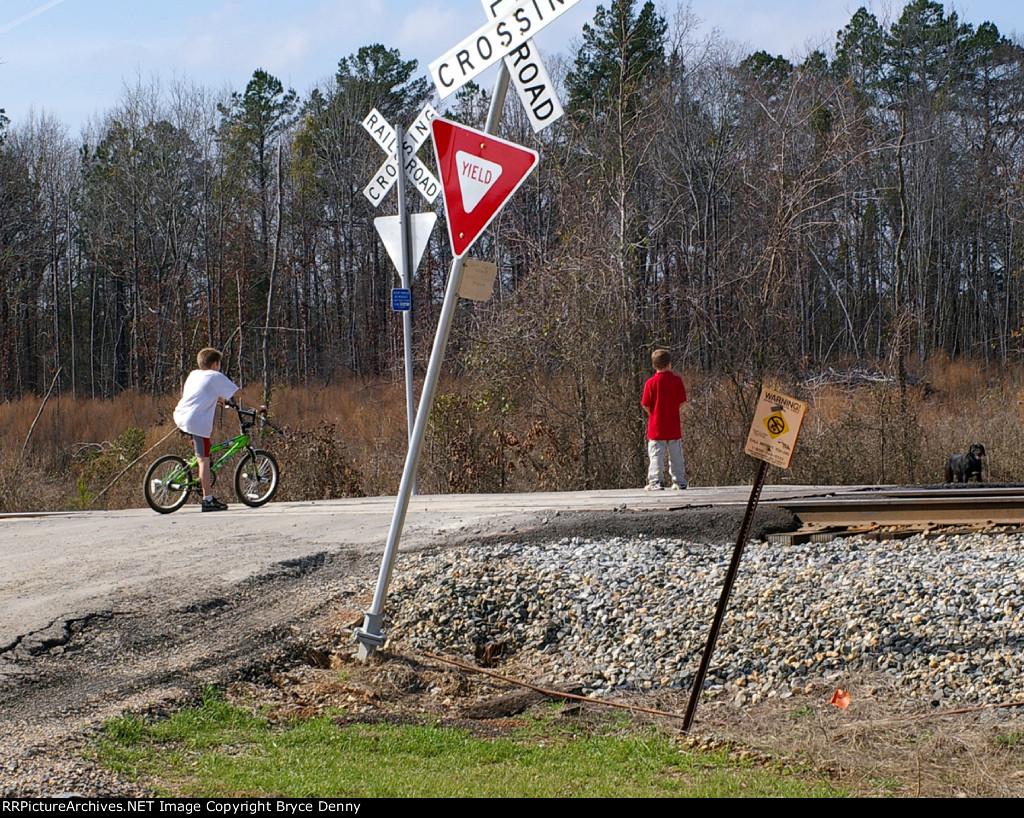 As KCS train approaches, kid on bicycleplays "chicken."