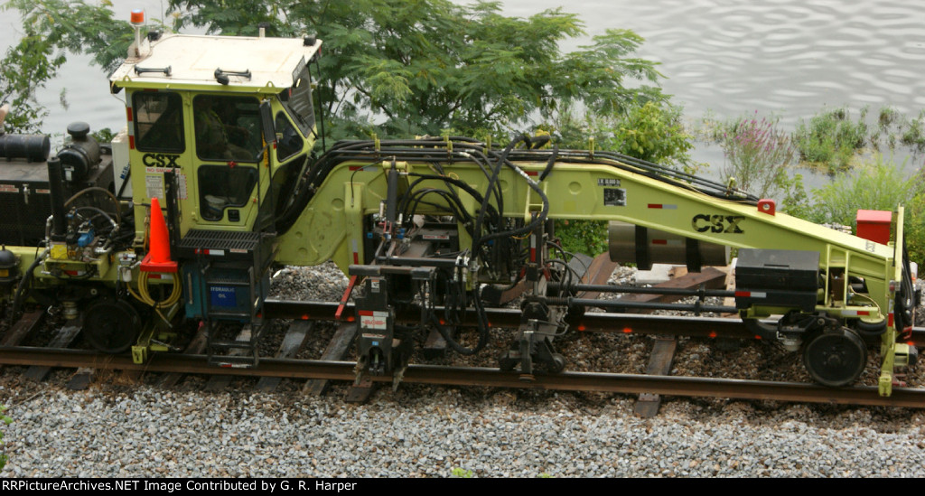 The same machine that yanked out the concrete ties inserts the new wood ties under the rail