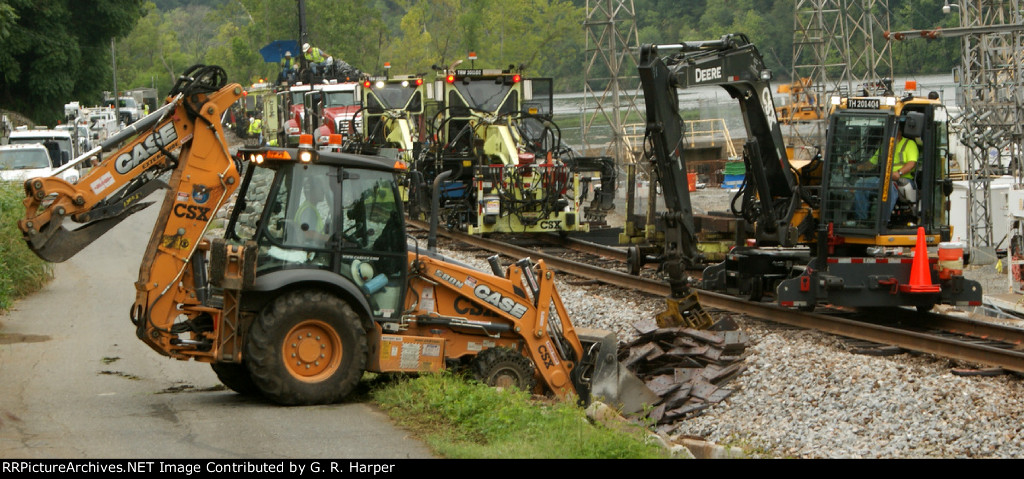 Tie handler scoops tie plates into a front end loader to be carried to a more needed location