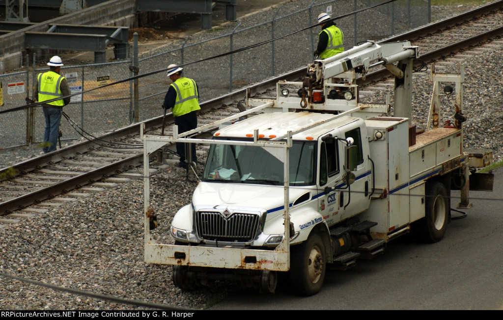 M of W tamping ballast by hand underneath soft spot on the main line