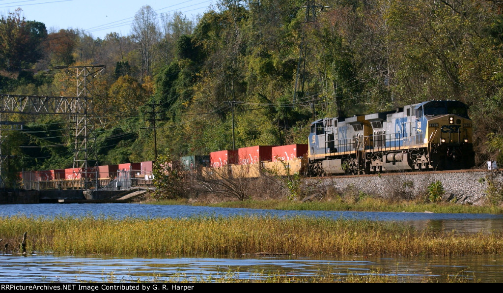 487 - Container train Q13520 westbound just above the dam at Reusens