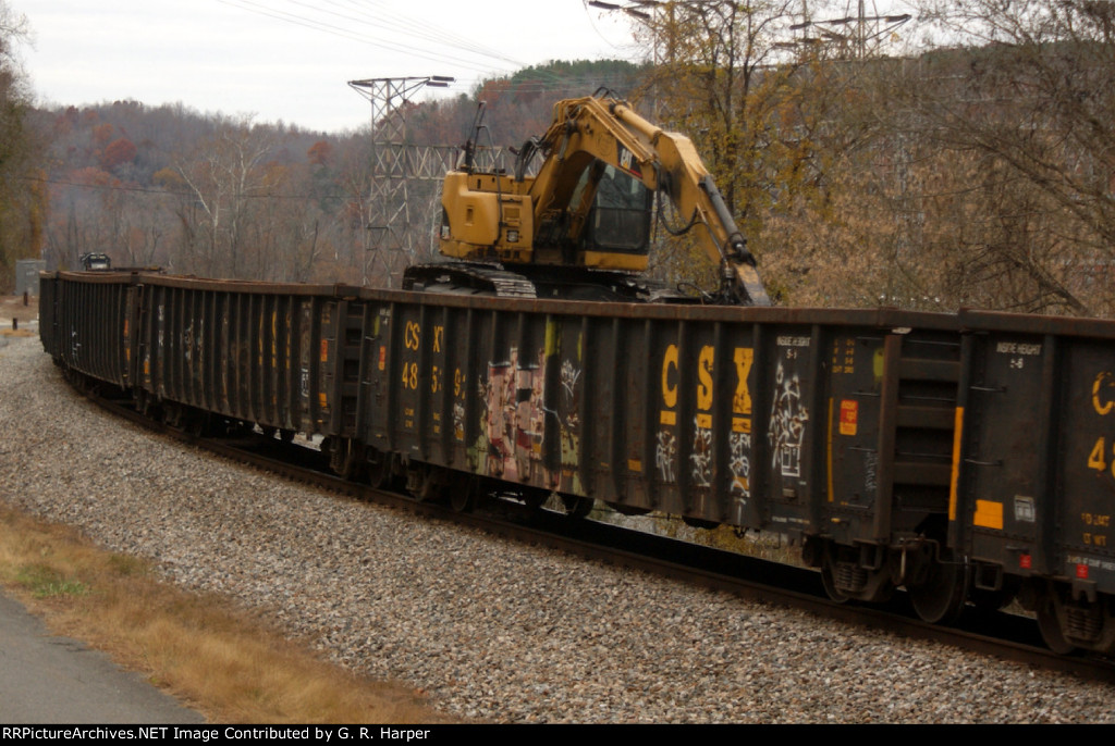 Excavator sits in gondola car on the B01213 westbound