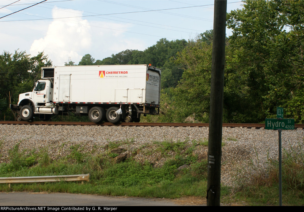 Curve patch gang clears up at the west end of Reusens.