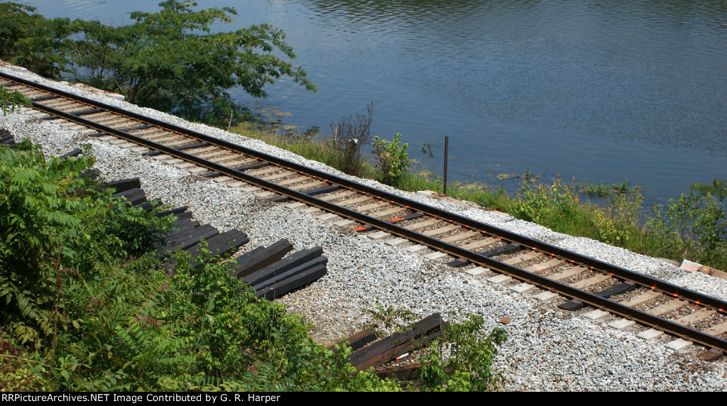 View from the back yard of markings on rail where wood ties will go.  Five wood ties in place of four existing concrete ties