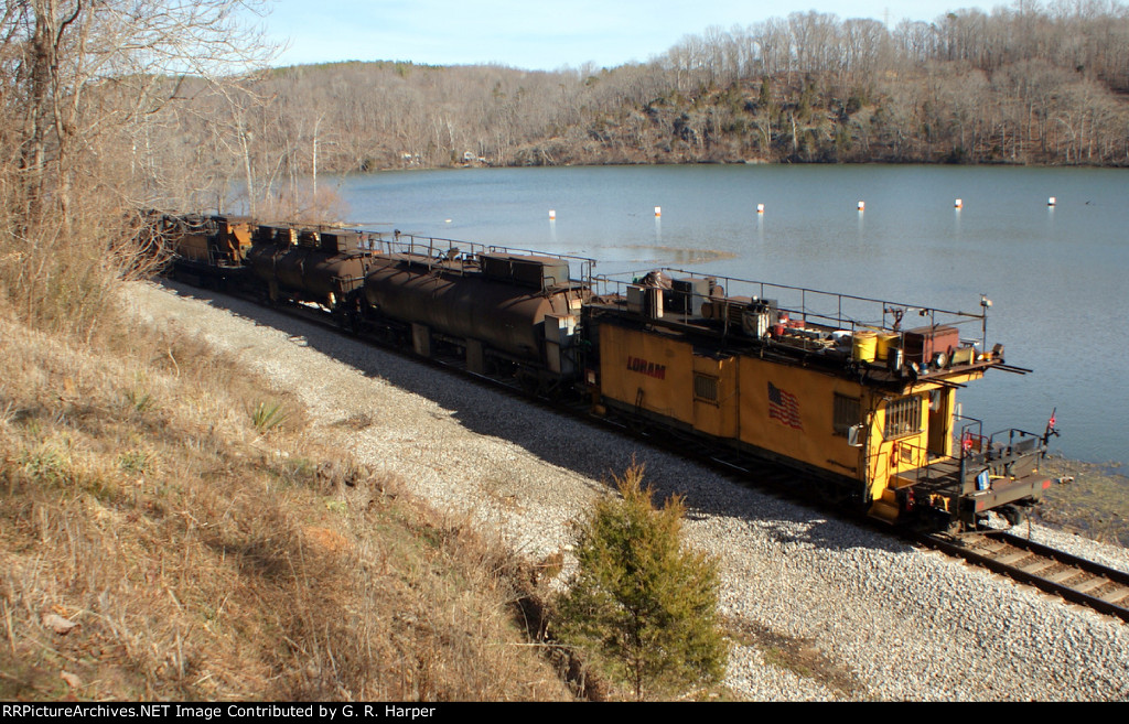 702 - rear of Loram rail grinding set drifts westward.