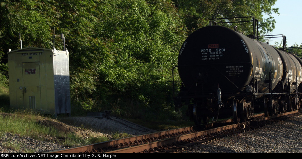 Rear of K89715 passes by the Reusens DD bungalow, now cleaned up after having been tagged a week ago