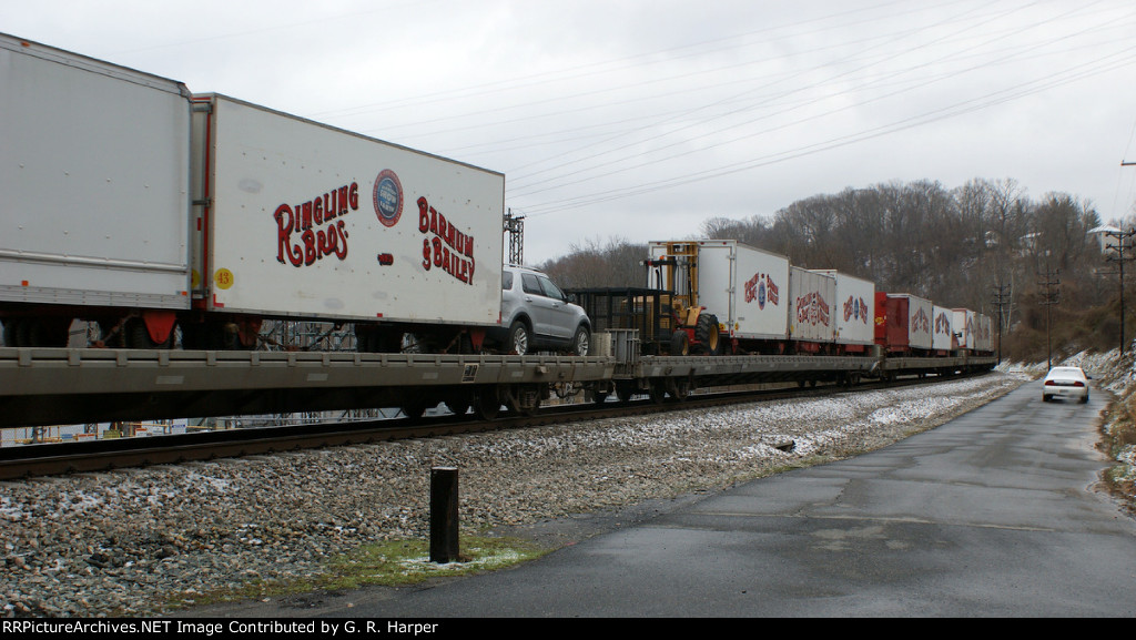 782 - Ringling Bros. wagons on flats along Hydro St. My neighbor in car watches.