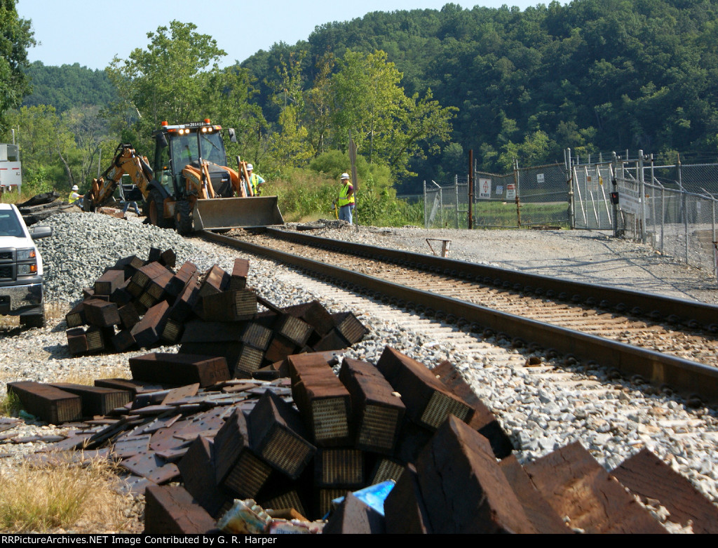 Tie gang removes the grade crossing into the Reusens power plant in preparation for tie replacement