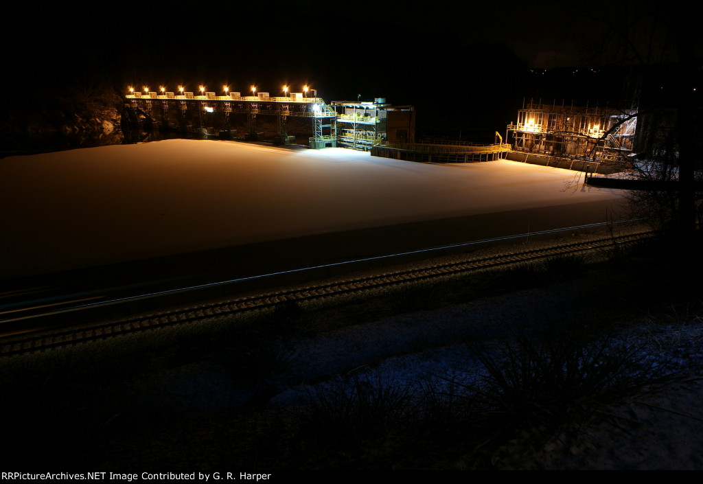 707 - The U757 streaks by the frozen over Reusens Dam pond freshly covered with an inch of snow