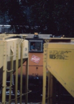 1368-09 MILW MP15AC peeks through cars at Pigs Eye Yard