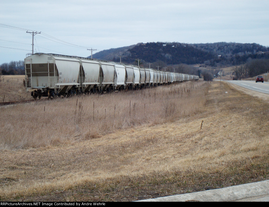 MQRX 113374 at the end of a string of stored hoppers