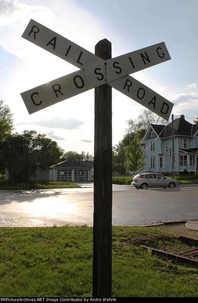 Backlit Cordelia St. crossbuck and end of the rails
